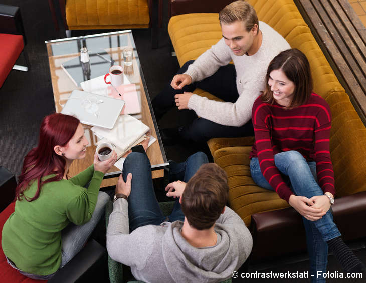 	 Young people sitting on a couch and talking to each other