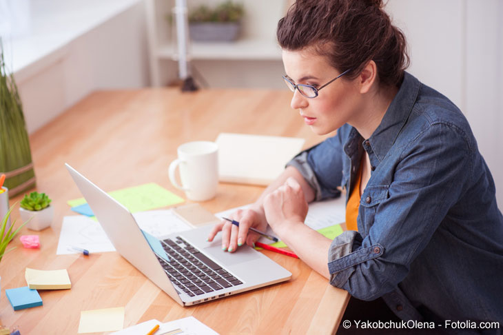 Young woman sitting in front of her laptop.